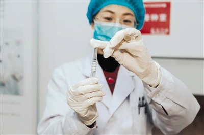 4月16日，江苏省徐州市睢宁县，工作人员展示第一支临床用新型冠状病毒灭活疫苗。王春辉 摄