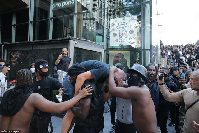 英白人男子在抗议中受重伤，黑人男子扛其到安全地带：想让他活着