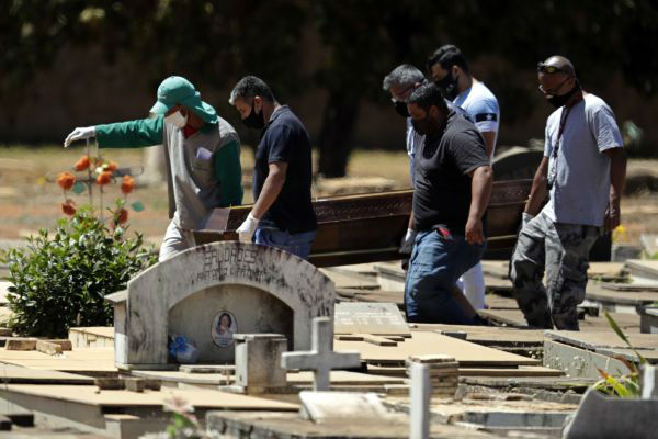  9月3日，在巴西首都巴西利亚，工作人员搬运一位新冠死亡患者的遗体。新华社/美联