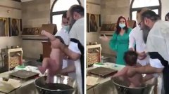 塞浦路斯一位牧师给婴儿做洗礼遭到投