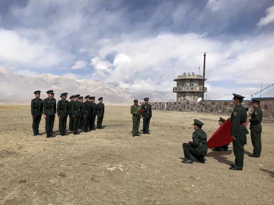 ▲官兵们在昆木加哨楼前重温入党誓词。摄影:新京报记者曾金秋